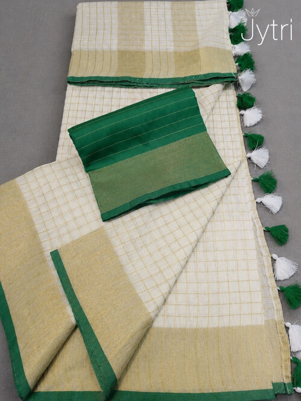 Elegant cream cotton saree with golden zari weaving and green border pallu