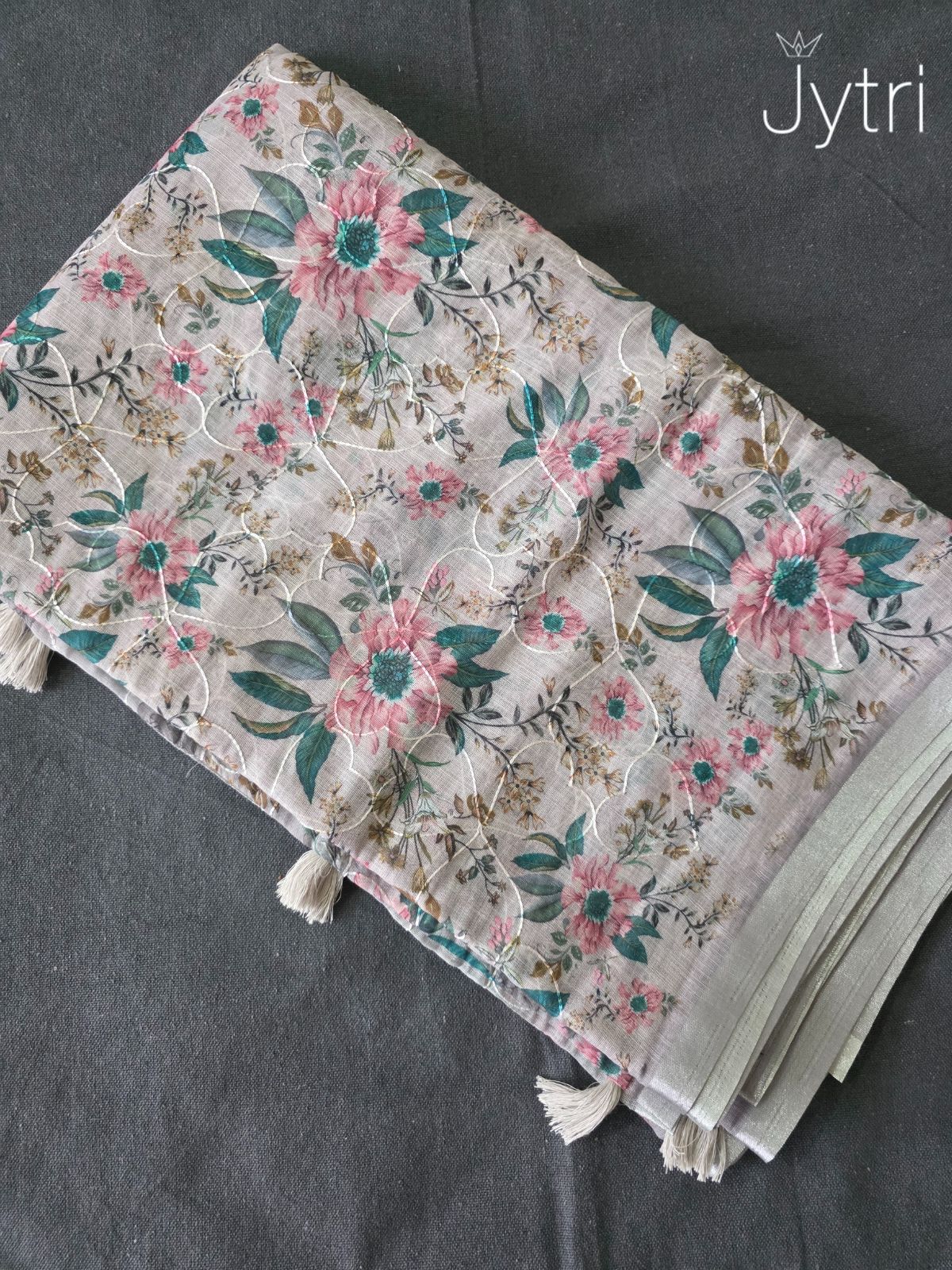 Floral fabric with tassels on a gray background