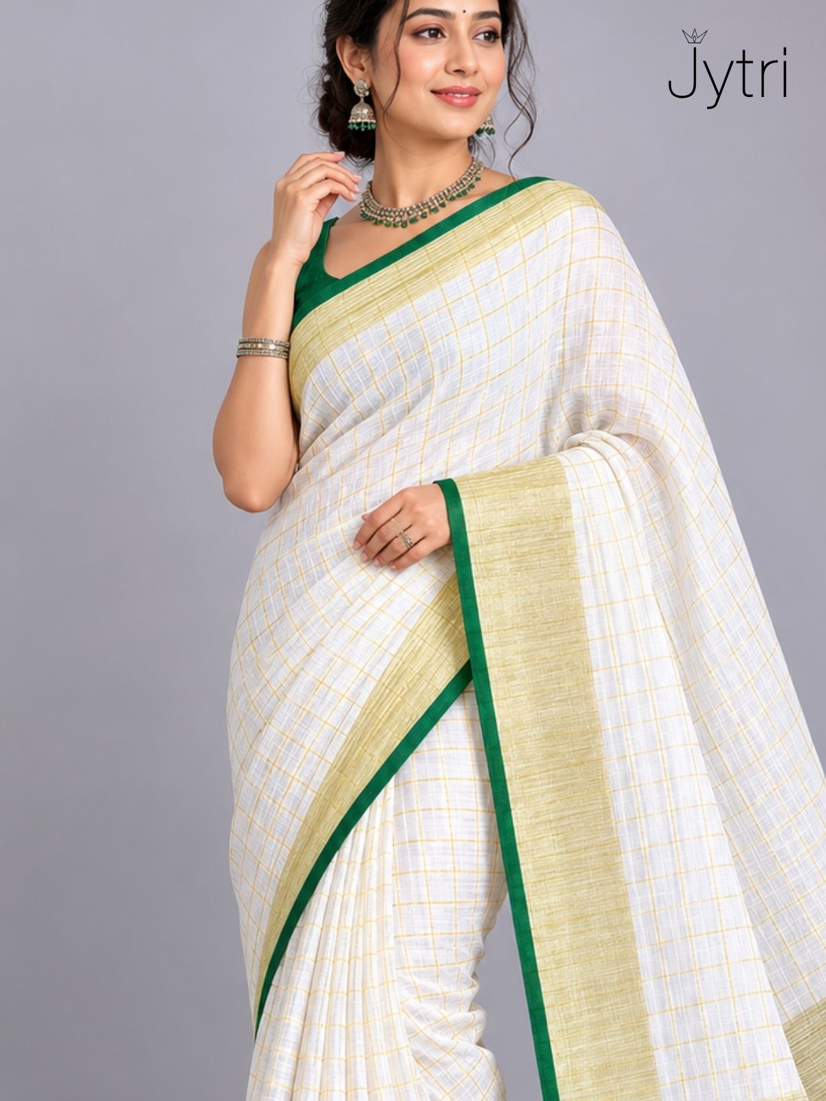 Woman wearing off white slub cotton saree with green border and zari box pattern