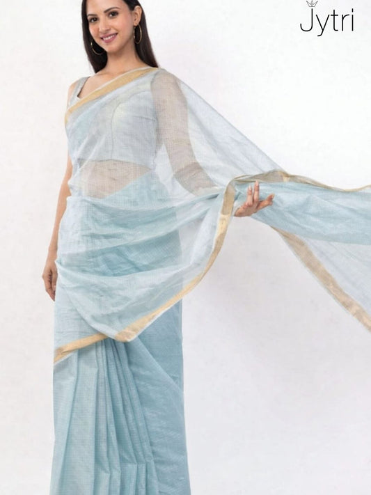 Woman wearing sky blue Kota Doria saree with golden border and sheer pallu